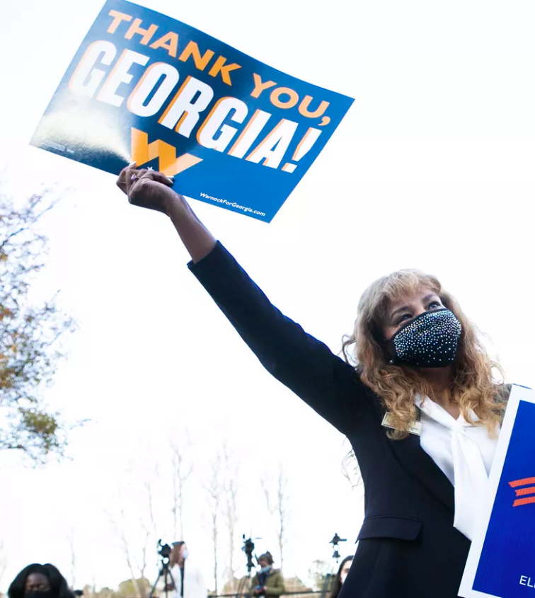 woman holding election sign